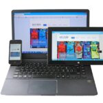 3 A website with responsive design being showcased on a laptop, tablet, and a mobile phone at a web design firm.