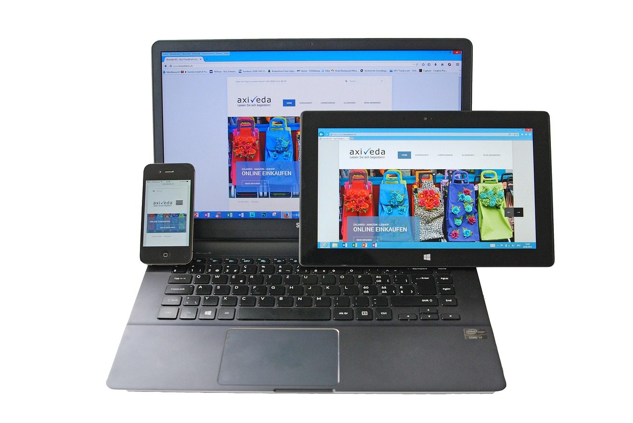 3 A website with responsive design being showcased on a laptop, tablet, and a mobile phone at a web design firm.