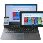 3 A website with responsive design being showcased on a laptop, tablet, and a mobile phone at a web design firm.